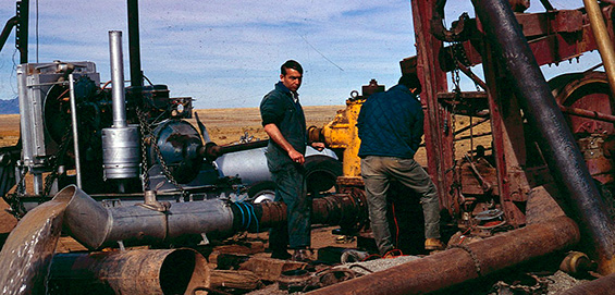 Image of two students working on a drill.