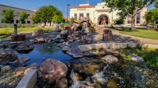 Exterior image of waterfall and lake in front of the Bureau of Geology Building