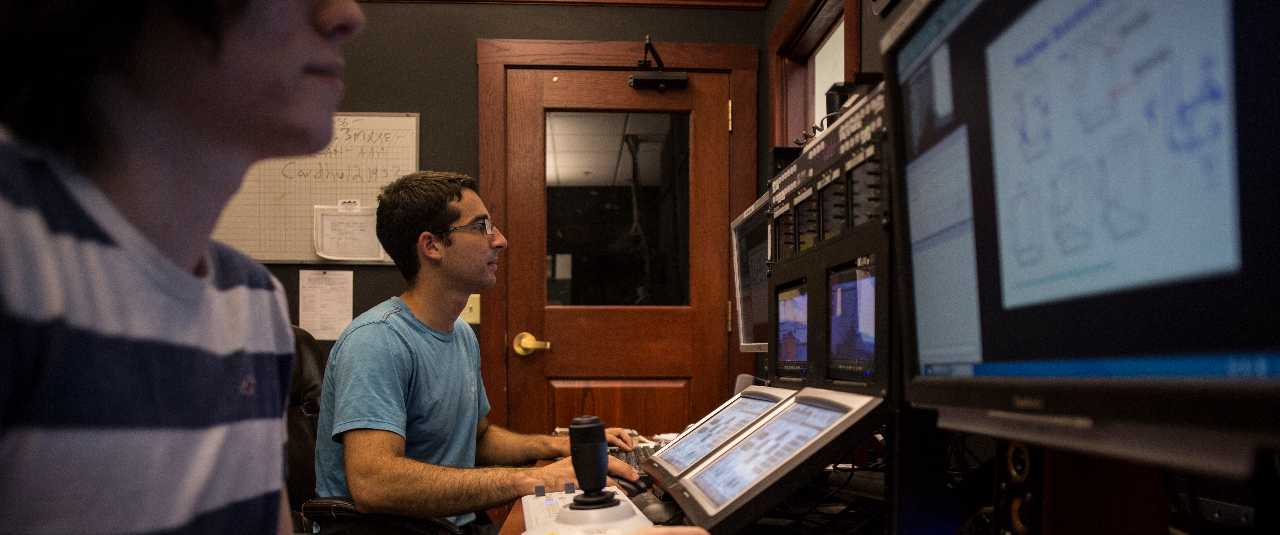 Students monitor distance education classrooms.