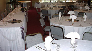 Image of tables and place settings set up for a wedding reception in Macey Center.