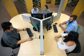 NMT students sitting at computer lab pod