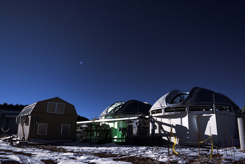 Aerial photo of MROI with telescopes superimposed to show artist's rendition of the completed astronomical facility. The MROI will simulate a telescope up to 347 meters in diameter when it is completed. Today MROI has 2 telescopes on the array. (Photo Credit: Tyson Eakman and Andres Olivares (MROI))