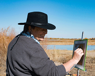 Natasha Isenhour painting a still life outdoors