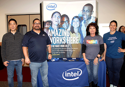 Intel recruiters pose at their booth