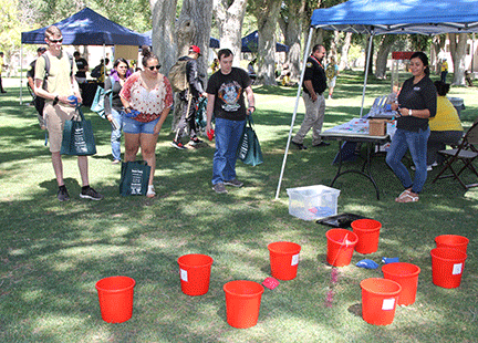 students play bean bag toss