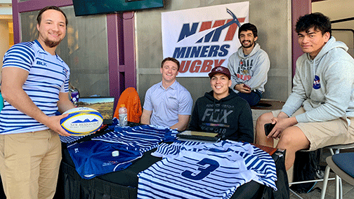 Rugby players host an info table