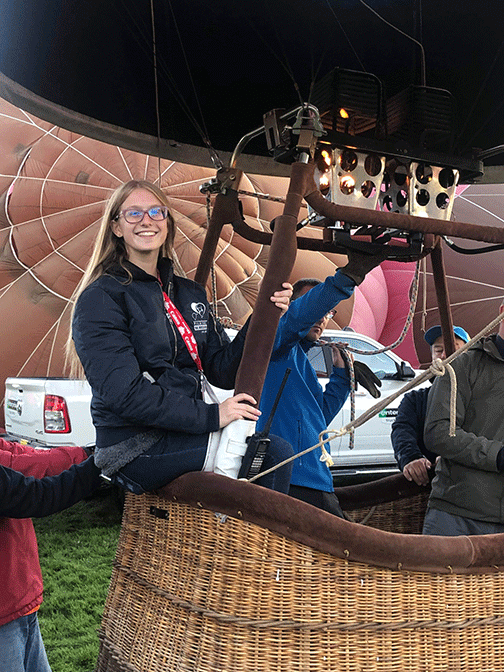 Savannah Bradley poses in her balloon gondola