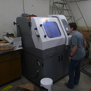 Student standing with equipment